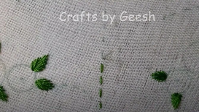 Hand embroidery heart outline being created using a simple running stitch with red thread.